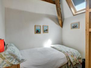 a bedroom with a bed and two pictures on the wall at Allerford- Ukc4920 in Timberscombe