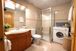 a bathroom with a sink toilet and a washing machine at Casa Marga - " Pet friendly - Piscina Privada - Playa - BBQ - Parking - Delta de l'Ebre - Riumar" in Riumar +15 photos