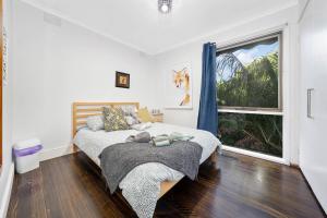 a bedroom with a bed and a window at Relax Refresh Rejuvenate Pool Cabin Garden Tree house Vintage charm in Berwick +27 photos