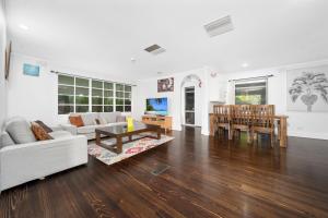 a living room with a couch and a table at Relax Refresh Rejuvenate Pool Cabin Garden Tree house Vintage charm in Berwick