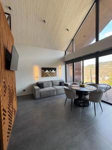 a living room with a couch and a table at Stodola Slavsko котедж з чаном-джакузі in Slavske