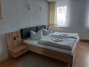 a bedroom with a large bed with pillows on it at Pension Reichel in Freiberg