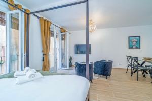 a bedroom with a bed and a table and chairs at The Art Flat in Figueres +43 photos