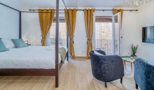 a bedroom with a canopy bed and a table and chairs at The Art Flat in Figueres