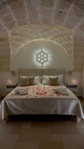 a bedroom with a large bed with a stone ceiling at Samy Suite in Fasano
