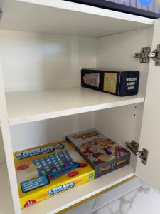 a shelf with some books and a box at The Green Shouse in Stanthorpe