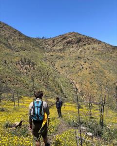 two people walking up a hill on a trail at Atlas House in Amizmiz