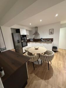 a kitchen with a table and two chairs in a kitchen at Appartement Ajaccio T3 in Ajaccio