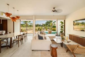a living room with a white couch and a table at Casita VR08 in Zihuatanejo +16 photos