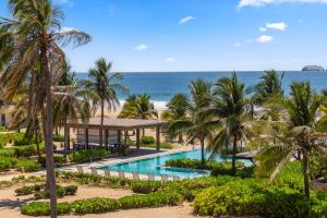 an aerial view of a resort with a swimming pool and the beach at Casita VR08 in Zihuatanejo