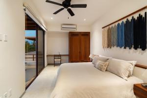 a bedroom with a bed and a ceiling fan at Casita VR09 in Zihuatanejo +16 photos