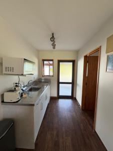a kitchen with a sink and a counter top at Mt Cook View Motel - Fox Glacier in Fox Glacier