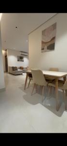 a dining room with a table and two chairs at شقة مفروشة in Al Khobar