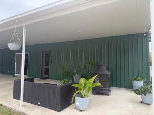 a green wall with potted plants on a patio at The Green Shouse in Stanthorpe