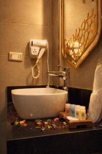 a bathroom with a white sink and a mirror at Zaytun Hotel Dahab in Dahab
