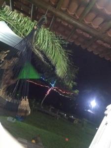 a christmas tree hanging from a roof at night at Acampamento Dos Frangos in Itabuna