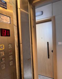 a elevator with a door in a room at Seashore Happiness Apartments in Porto Rafti