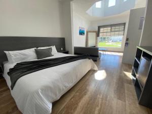 a bedroom with a large bed and a large window at Vita Grand San Miguel de Allende in San Miguel de Allende +22 photos