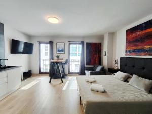 a large living room with a bed and a couch at Suite imperial Muralla de Lugo 2.2 in Lugo +4 photos