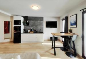 a kitchen with a table and a dining room at Suite imperial Muralla de Lugo 2.2 in Lugo