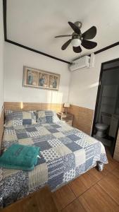 a bedroom with a bed and a ceiling fan at Residencial Las Palmeras in Iquique