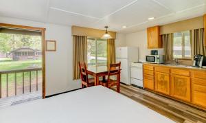 a kitchen with a table and chairs and a refrigerator at Sol Duc Hot Springs Resort in Ovington