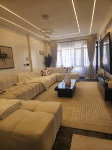 a large living room with couches and a coffee table at Cozzy homes in Ngong