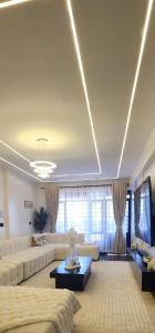 a large living room with couches and a table at Cozzy homes in Ngong