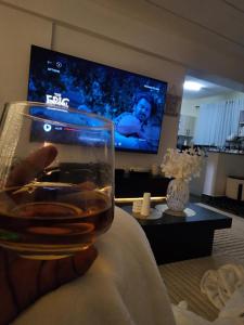 a person holding a glass of wine in a living room at Cozzy homes in Ngong