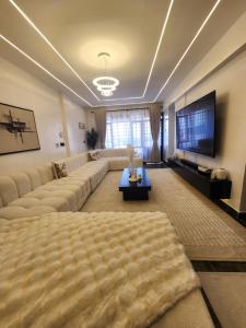 a living room with a couch and a flat screen tv at Cozzy homes in Ngong