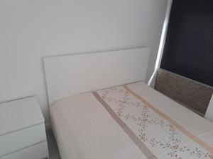 a small bedroom with a bed in a room at Casa da Figueira in Aguiar da Beira