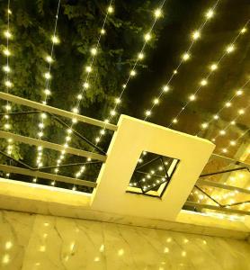a stage with lights on the ceiling and a sign at The Moksha Residency in Prayagraj