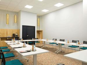 a conference room with tables and chairs and a chalkboard at Ibis Abdelmoumen Casa Centre in Casablanca
