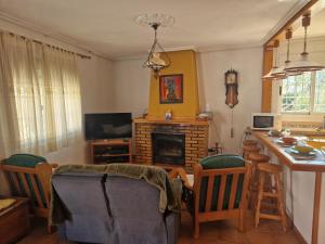 a living room with a table and a fireplace at Casa Dulcinea in Alborea