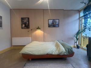 a bedroom with a bed in a room with a lamp at Sauna Haus in Brighton & Hove
