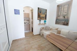 a living room with a couch in a room at Rania Bella Vista Studios in Poros