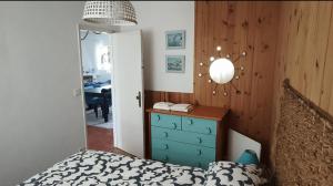 a bedroom with a bed and a dresser and a mirror at Casa de Praia in Vila do Conde