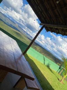 a wooden table with a view of the ocean at Casa vista da serra in Santana do Riacho