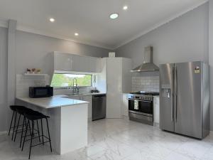 a kitchen with stainless steel appliances and a counter at The Green Shouse in Stanthorpe