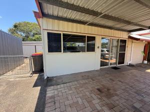 a garage with glass doors on a house at Hideaway on King in Urangan