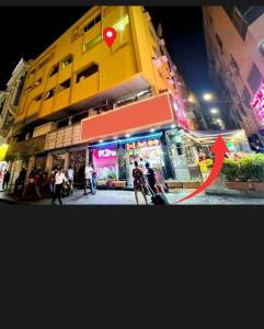 a woman standing outside of a store at night at United Holiday Homes in Dubai