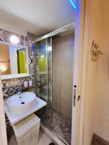 a bathroom with a sink and a shower at La Corte di Noto in Noto