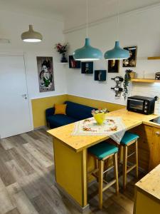 a kitchen with a table and a blue couch at La Corte di Noto in Noto