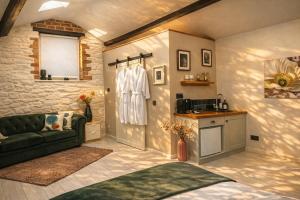 a living room with a couch and a kitchen at Linden Lodge at Lough Sillan House - Dog-friendly - Adults only in Shercock