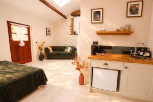 a bedroom with a bed and a kitchen with a sink at Linden Lodge at Lough Sillan House - Dog-friendly - Adults only in Shercock +19 photos