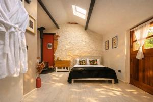 a bedroom with a bed and a brick wall at Linden Lodge at Lough Sillan House - Dog-friendly - Adults only in Shercock