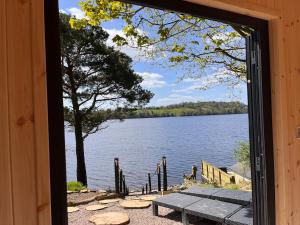 a window view of a lake from a cabin at Linden Lodge at Lough Sillan House - Dog-friendly - Adults only in Shercock