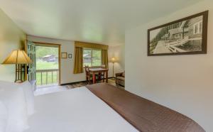 a bedroom with a large bed and a living room at Sol Duc Hot Springs Resort in Ovington