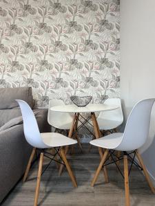 a dining room with a table and two chairs at Central Suites Silgar Sanxenxo in Sanxenxo +10 photos