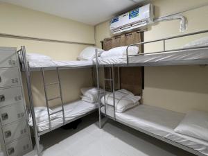 a room with three bunk beds in a hospital at United Holiday Homes in Dubai